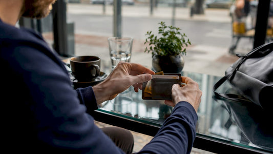 Hands placing cards into a minimalist wallet