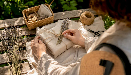 Hands wrapping eco-friendly gift with fabric