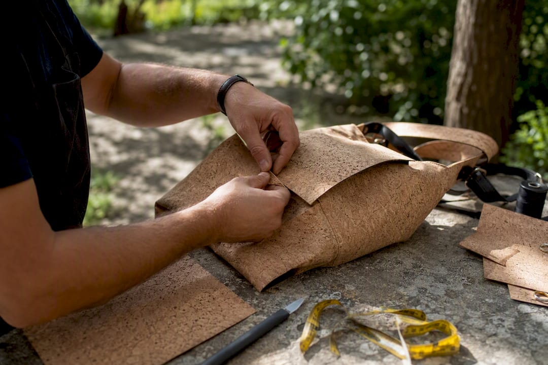 Hands smoothing Portuguese cork fabric