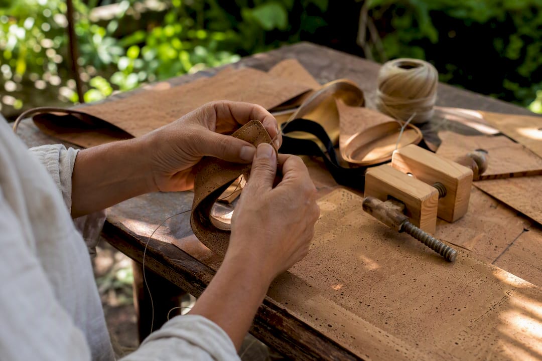 Hands crafting vegan cork jewellery details