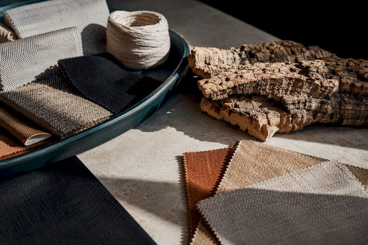 Sustainable fabric swatches beside cork bark