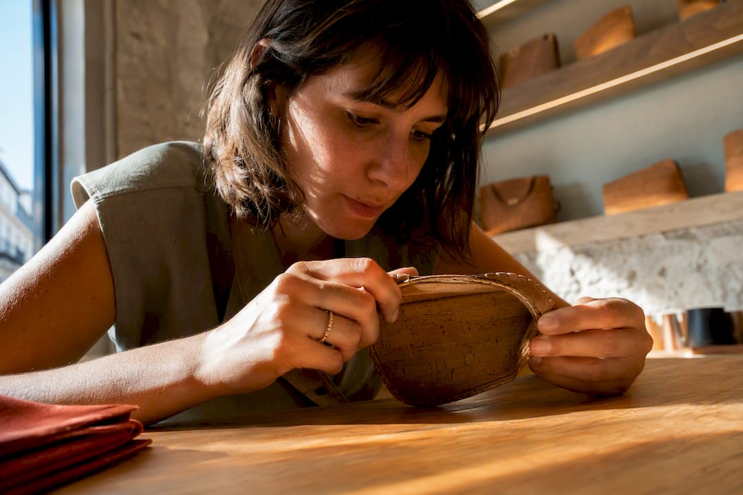 Shopper checking cork stitching in Lisbon