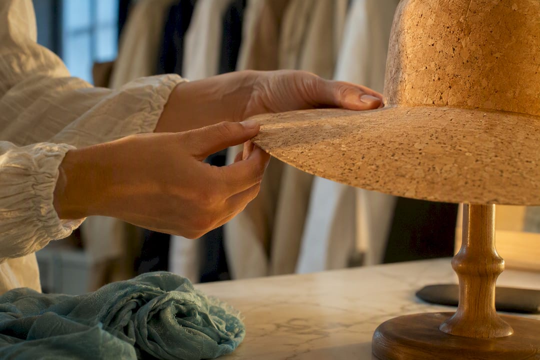 Hands checking a cork hat brim