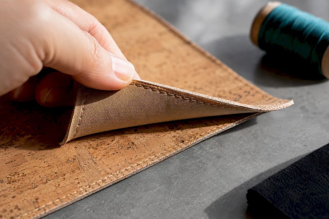 Inspecting cork backing and stitching detail
