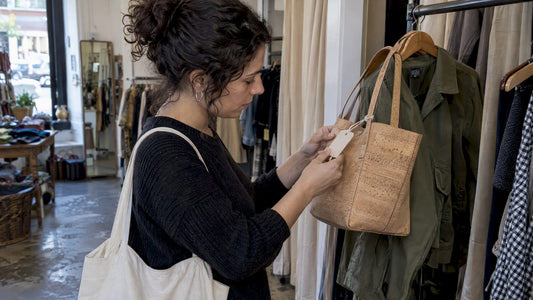 Shopper checking a cork handbag’s material tag