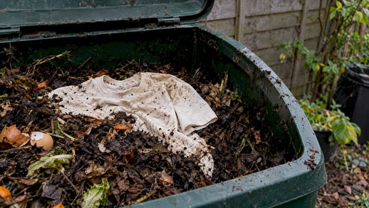 Undyed cotton shirt resting in active garden compost
